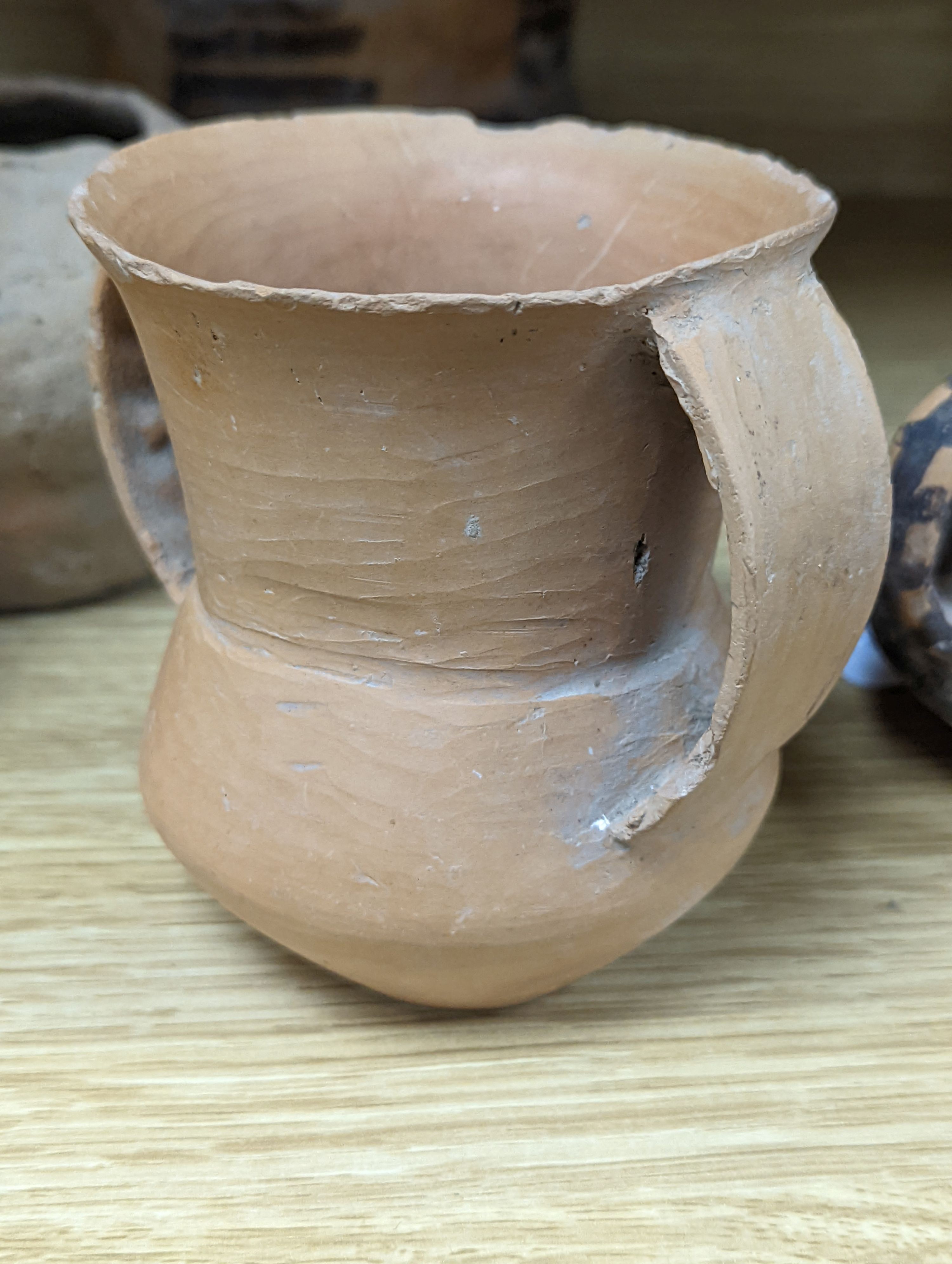 Four Chinese Neolithic pottery vessels, 11cm